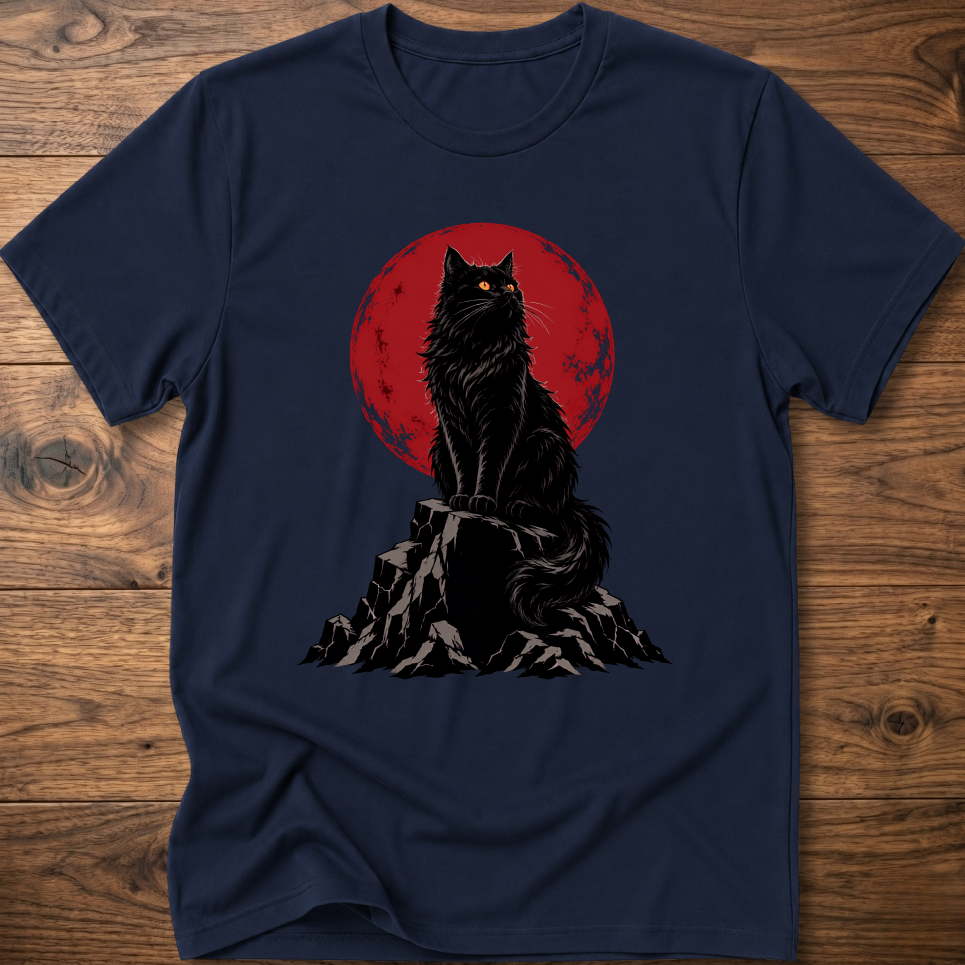 Navy t-shirt with black cat graphic on rocky ground inside red circle.