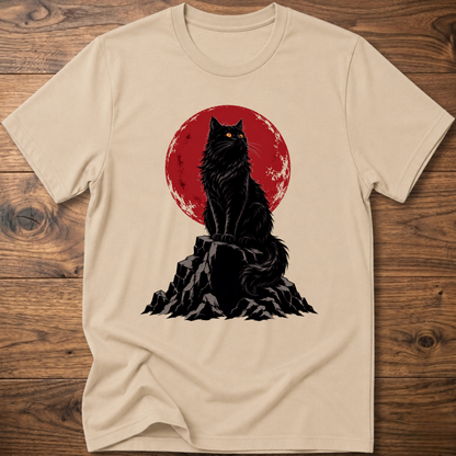Beige t-shirt with black cat graphic on rocky ground inside red circle.