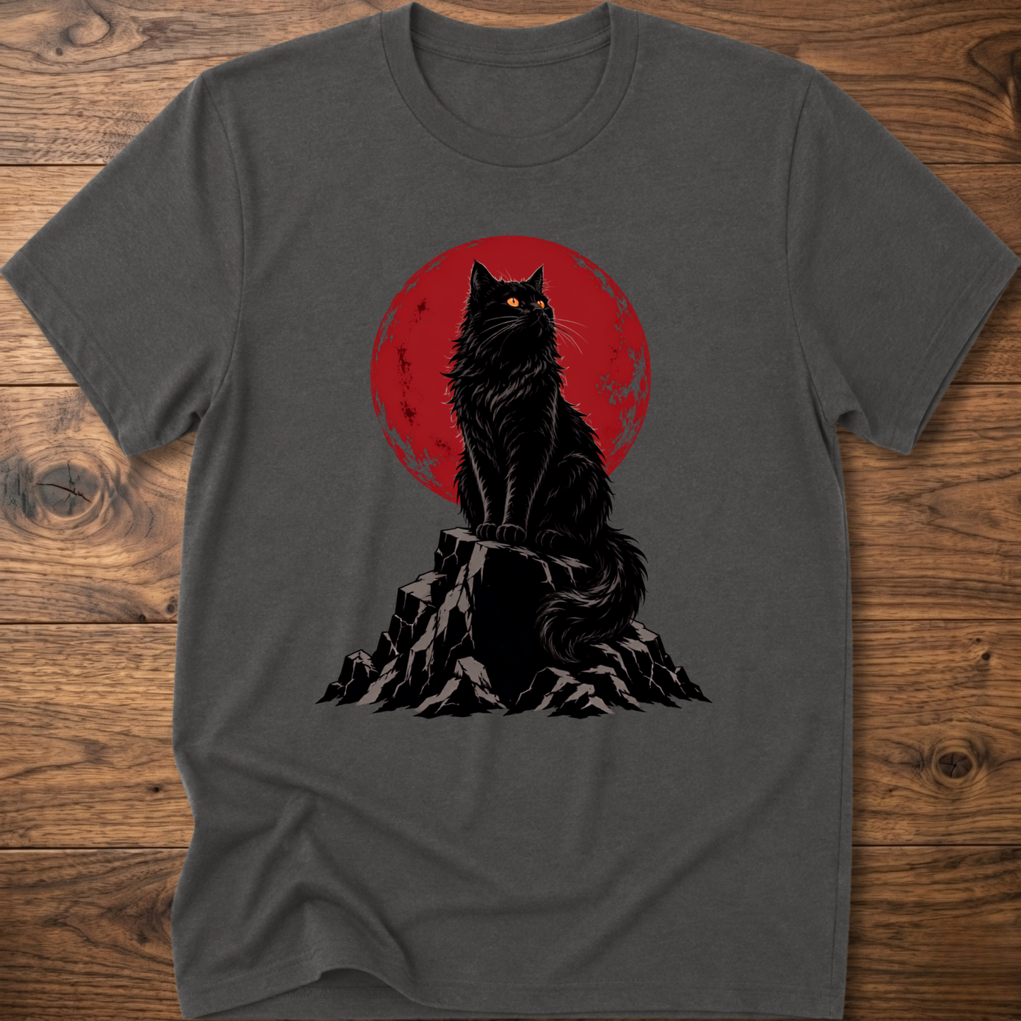 Charcoal gray t-shirt with black cat graphic on rocky ground inside red circle.