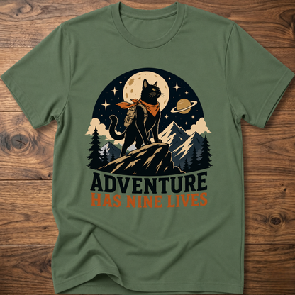 Military green cat graphic t-shirt, moonlit cat on mountains with 'Adventure Has Nine Lives'