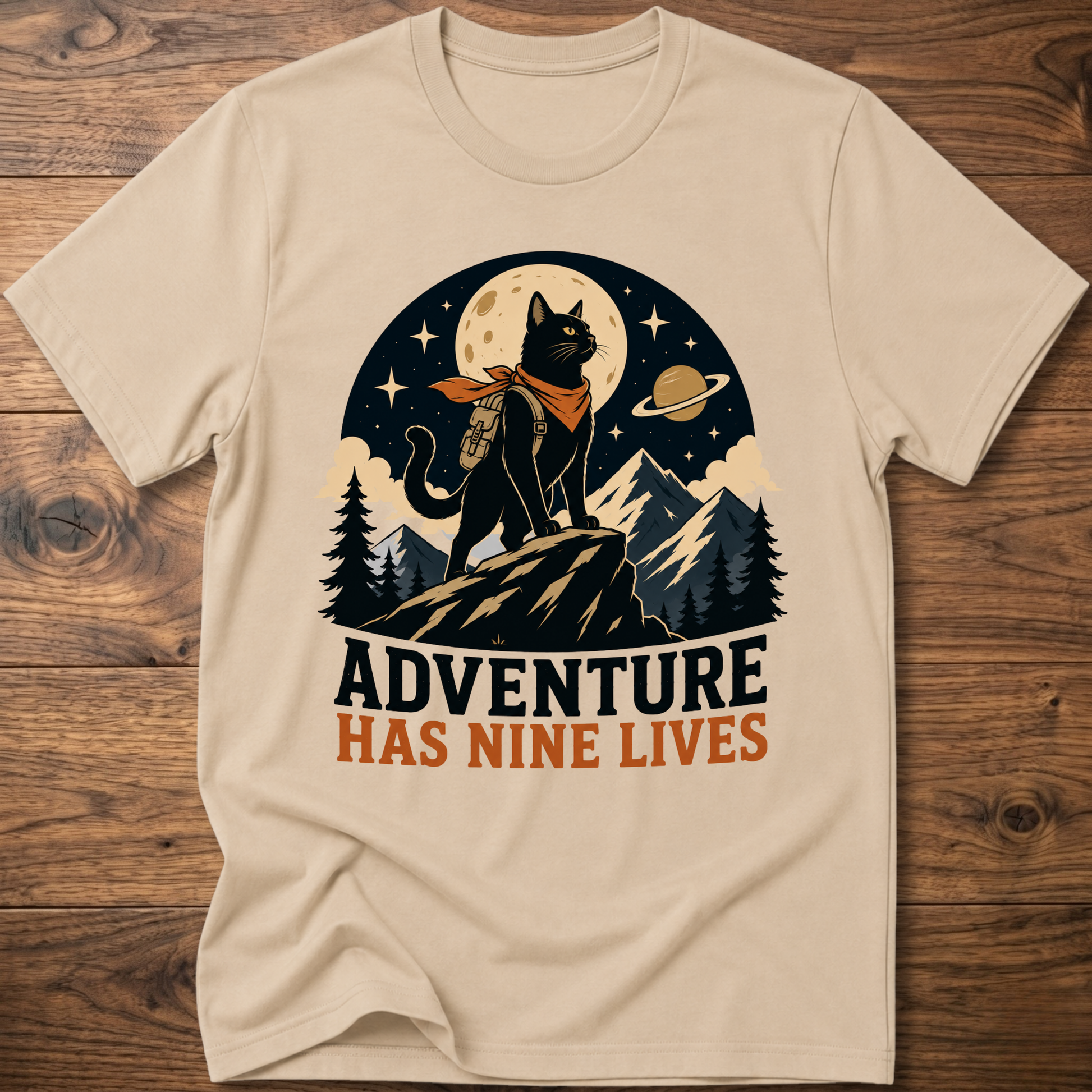 Sand cat graphic t-shirt, moonlit cat on mountains with 'Adventure Has Nine Lives'