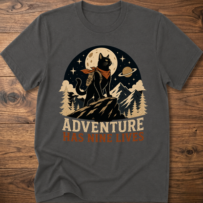 Charcoal cat graphic t-shirt, moonlit cat on mountains with 'Adventure Has Nine Lives'