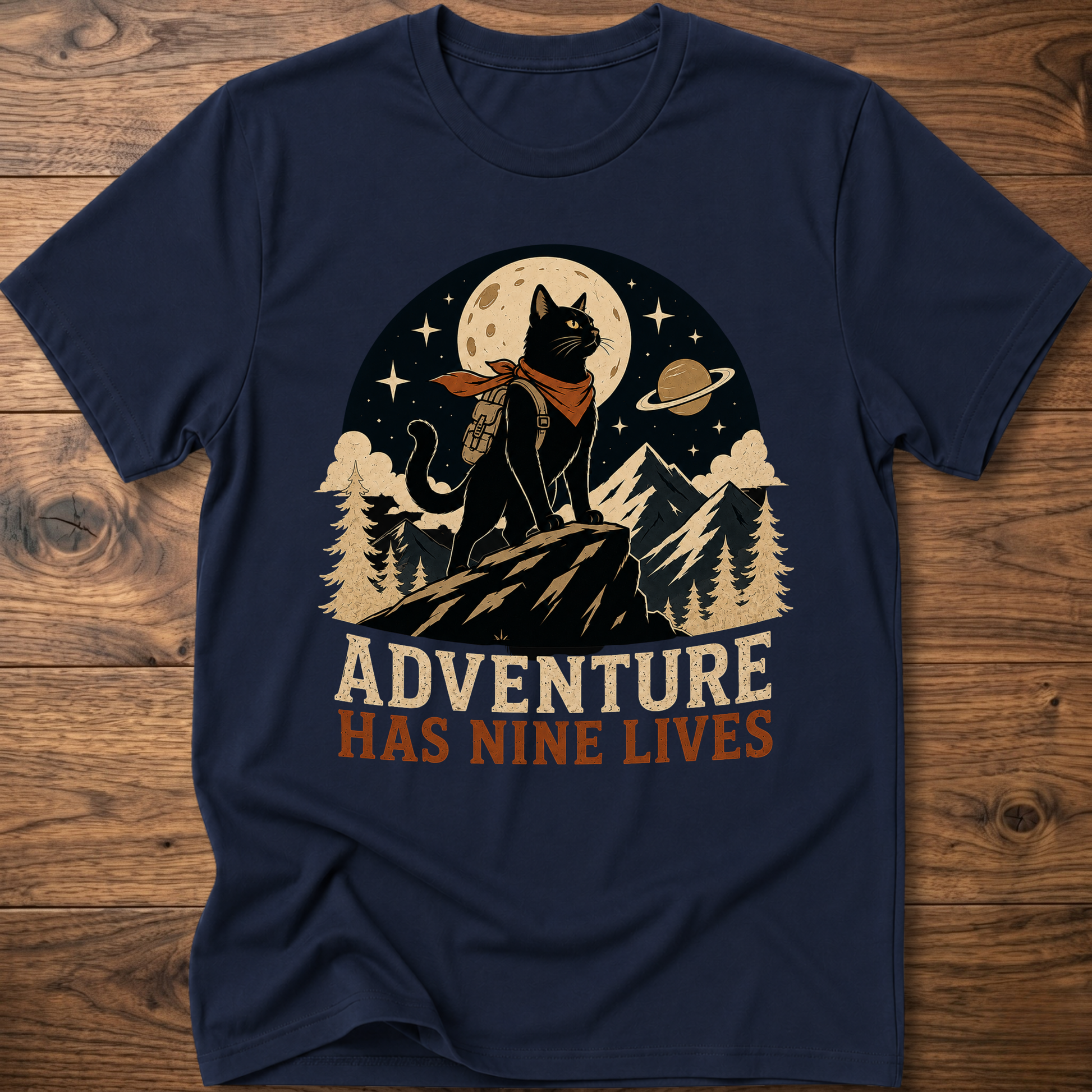 Navy cat graphic t-shirt, moonlit cat on mountains with 'Adventure Has Nine Lives'