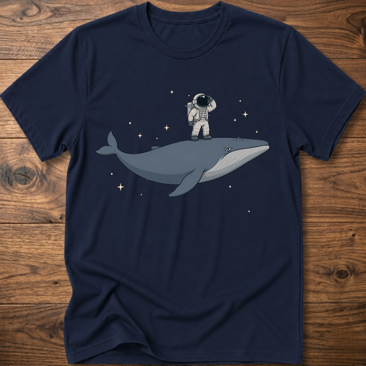 Navy blue short-sleeve t-shirt with astronaut riding a whale graphic and star accents