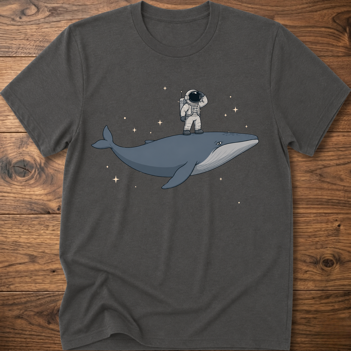 Charcoal gray short-sleeve t-shirt with astronaut riding a whale graphic and star accents
