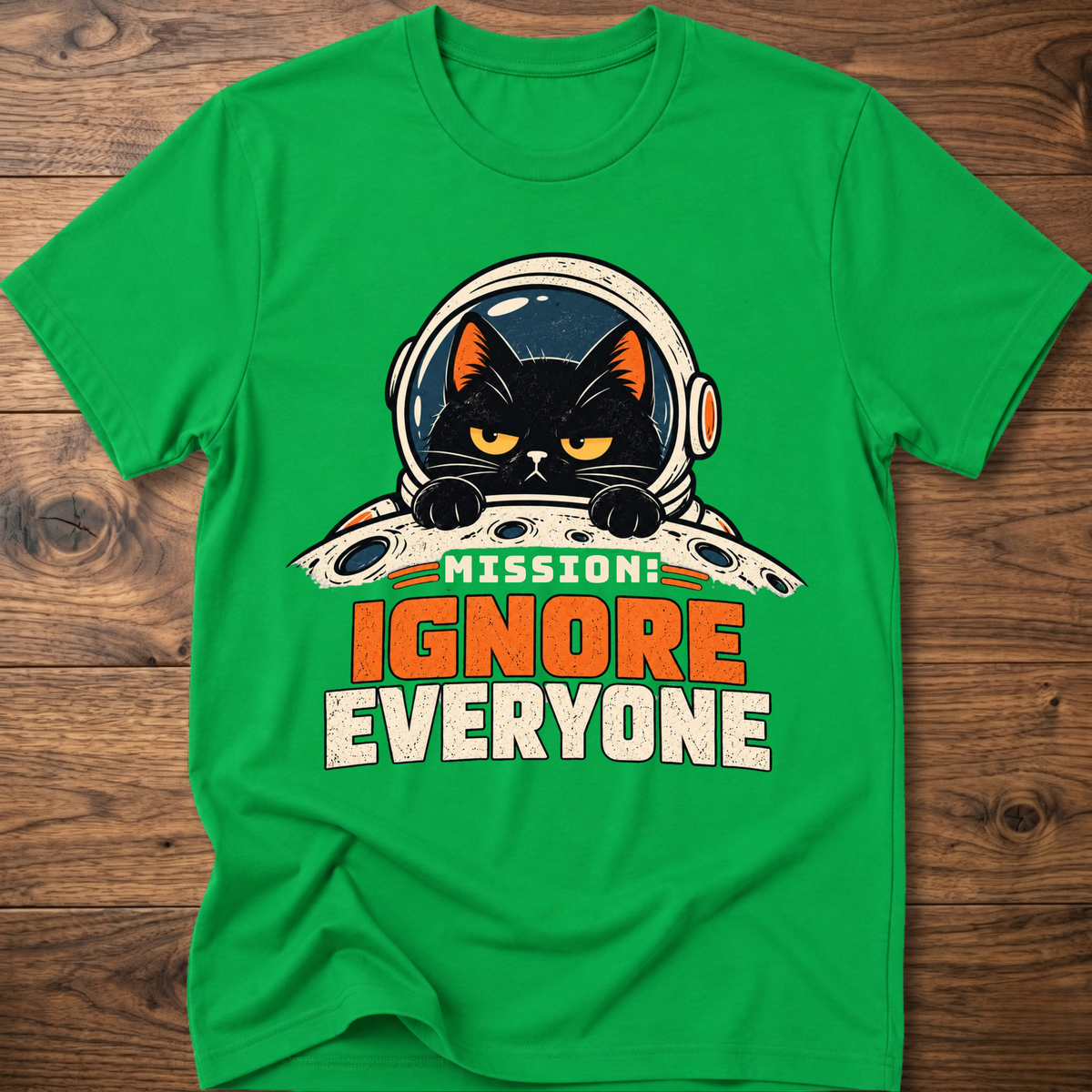 Irish green T-shirt with cat astronaut 'Mission Ignore Everyone' graphic.