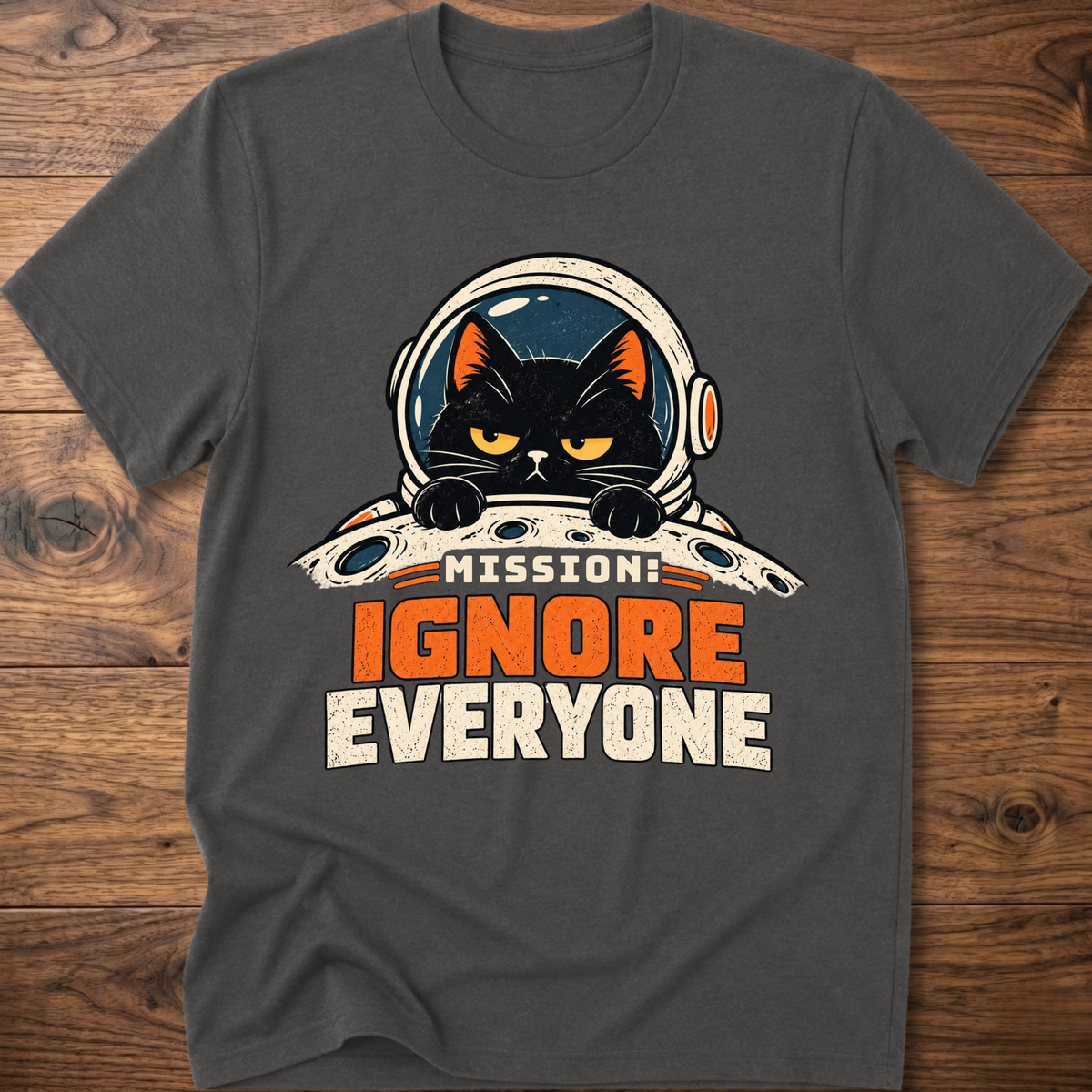 Charcoal T-shirt with cat astronaut 'Mission Ignore Everyone' graphic.