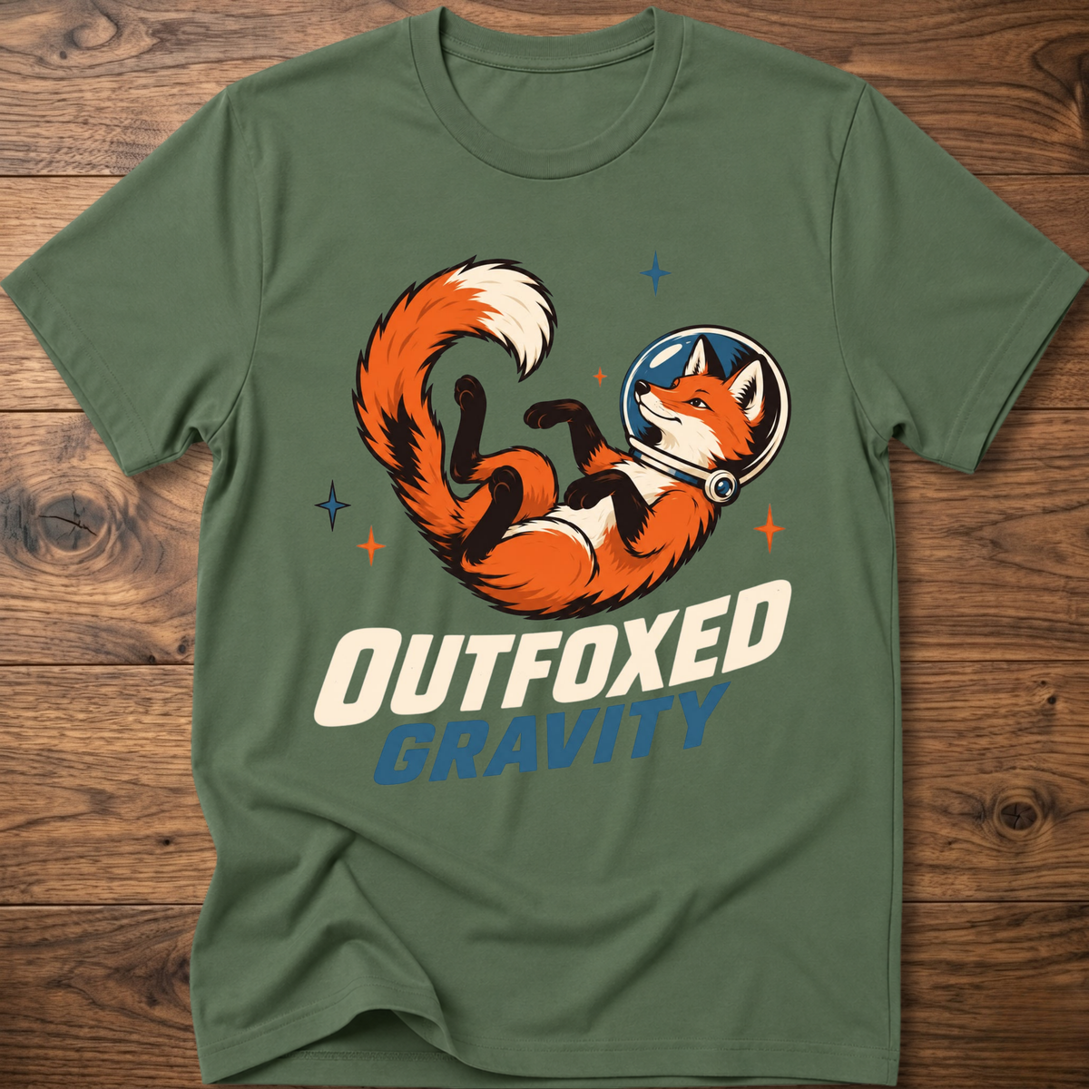 Outfoxed Gravity T-shirt in military green with orange fox gravity graphic and logo text