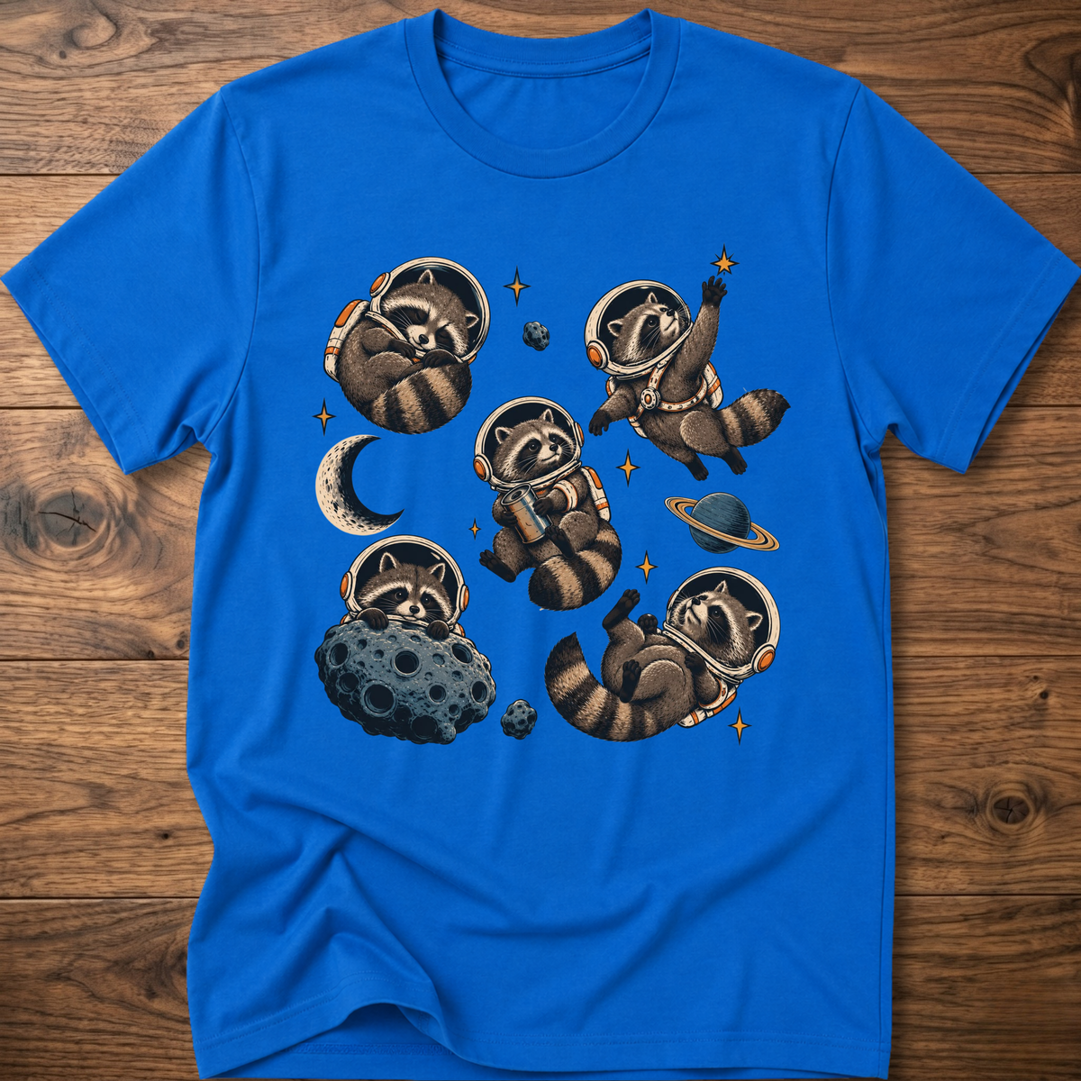 Bright blue crew T-shirt with raccoon astronaut space graphic on front