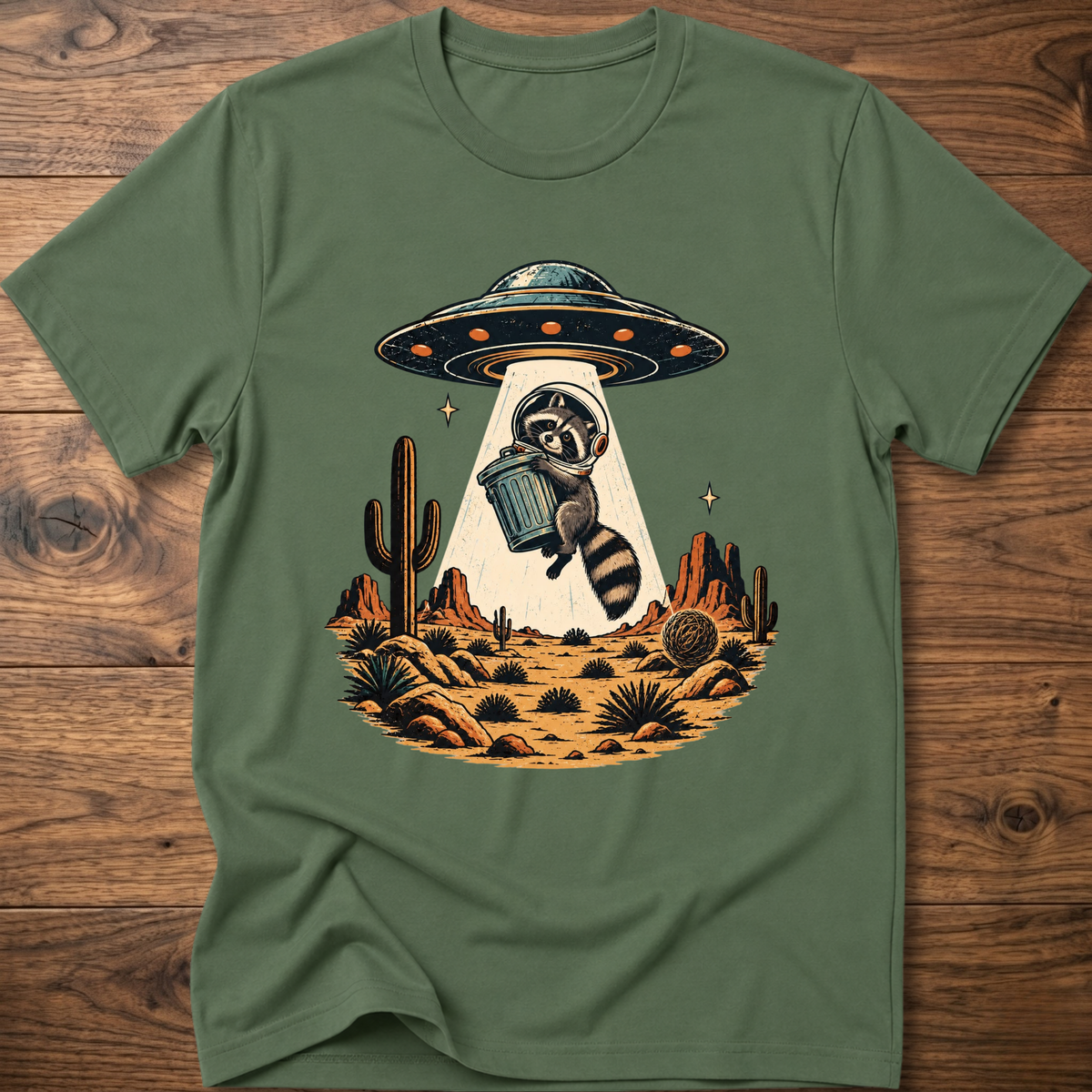 Military green crew-neck T-shirt with astronaut raccoon graphic, UFO, and desert cactus