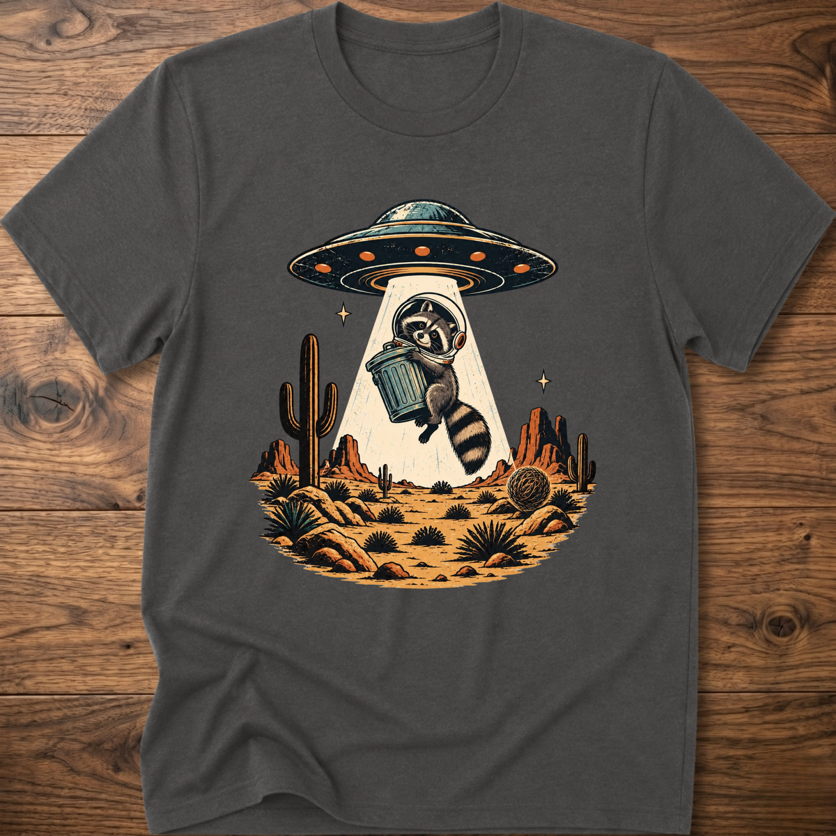 Gray crew-neck T-shirt with astronaut raccoon graphic, UFO, and desert cactus