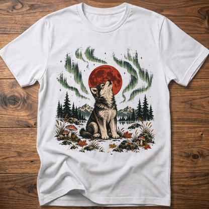 White t-shirt with seated wolf and red moon, green aurora forest scene print.