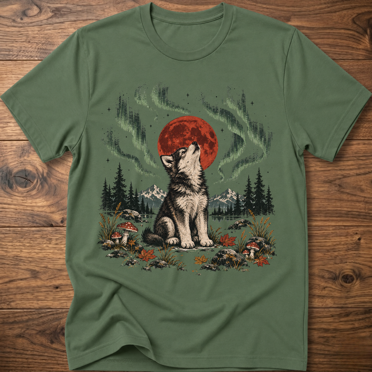 Military green t-shirt with seated wolf and red moon, green aurora nature graphic.