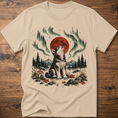 Sand t-shirt with seated wolf and red moon, green aurora forest graphic, crew neck.