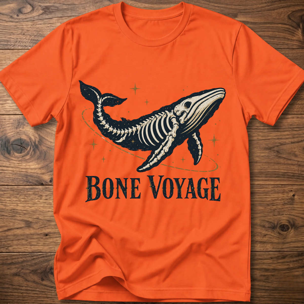 Orange whale graphic t-shirt with 'Bone Voyage' text and skeleton whale front print
