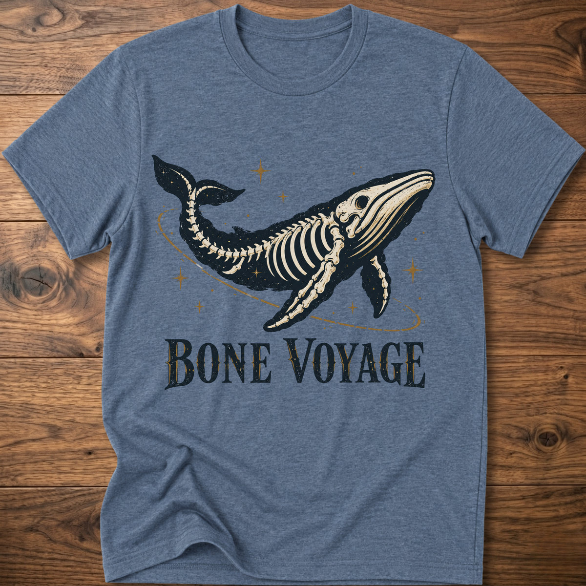 Heather blue whale graphic t-shirt with 'Bone Voyage' text and skeleton whale front print