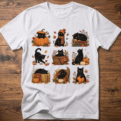 White cats in autumn graphic T-shirt with pumpkins, scarves, and leaves on front