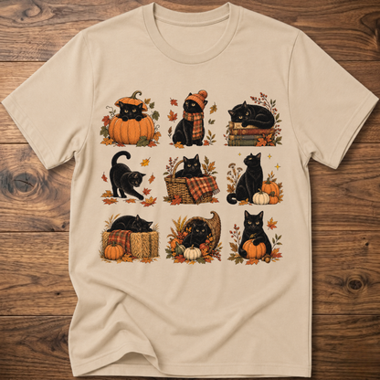 Sand cats in autumn graphic T-shirt with pumpkins, scarves, and leaves on front