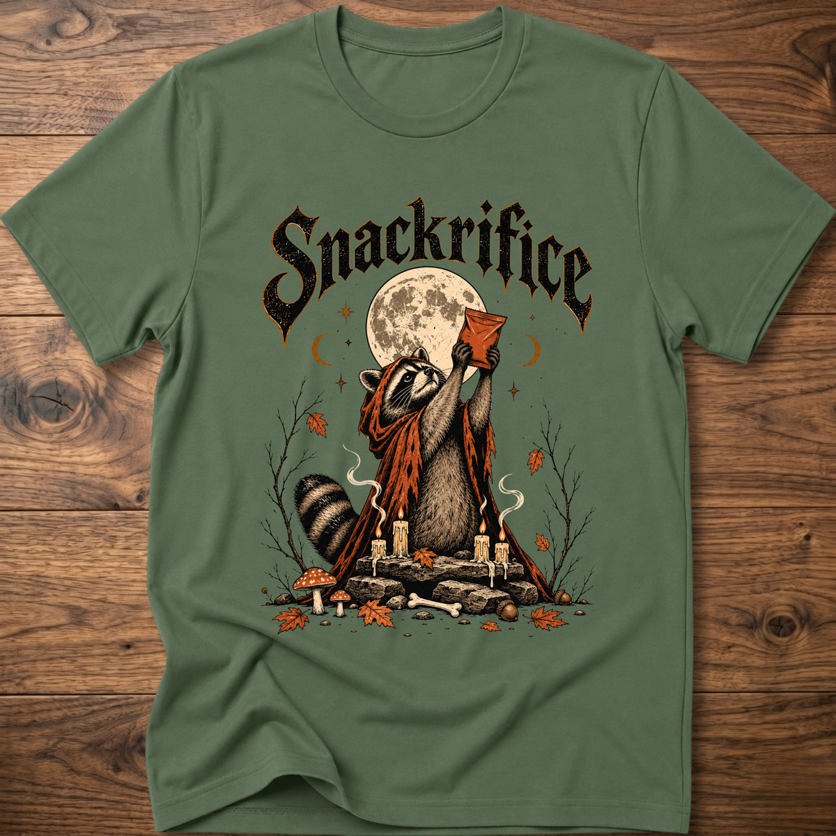 Green crew-neck t-shirt with black 'Snackrifice' raccoon moon front graphic