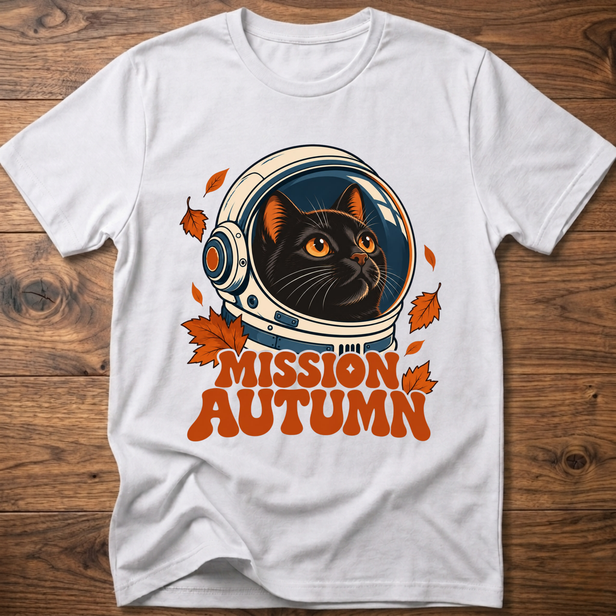 White cat astronaut graphic t-shirt with “Mission Autumn” text and fall leaf accents