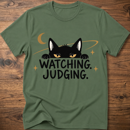 Military green crewneck T-shirt with black cat graphic and 'WATCHING JUDGING' text