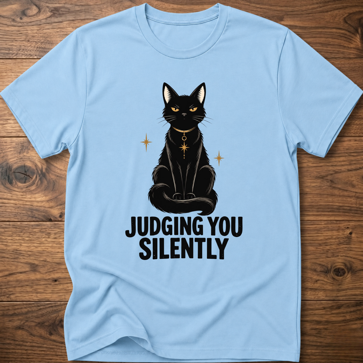 Light blue t-shirt with black cat graphic and text “JUDGING YOU SILENTLY”