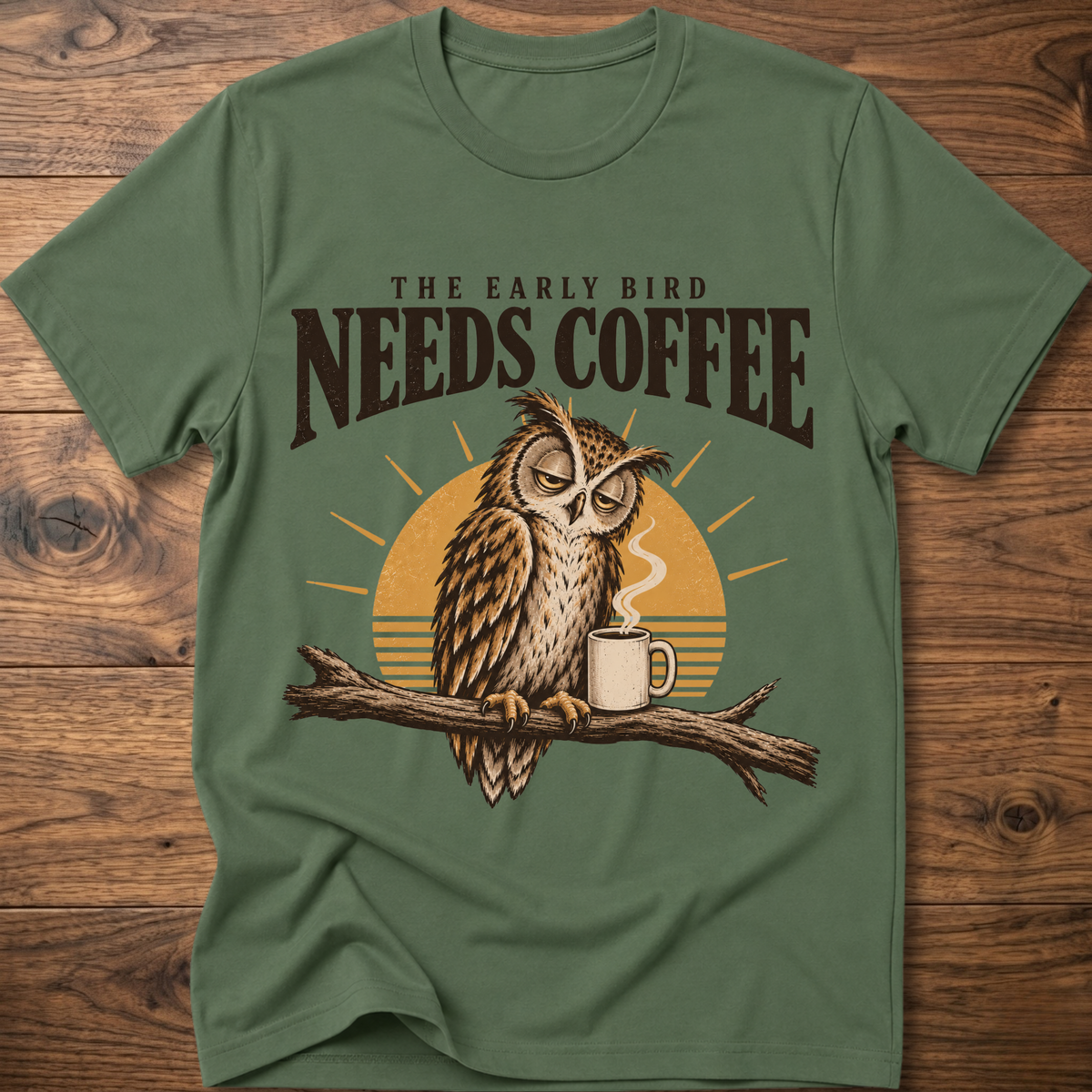 Green crew-neck T-shirt with owl perched on a branch beside a coffee mug graphic