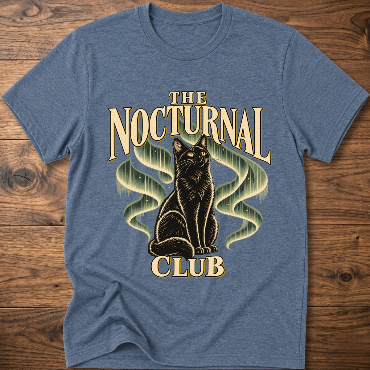 Heather blue T-shirt with “The Nocturnal Club” cat graphic on the front
