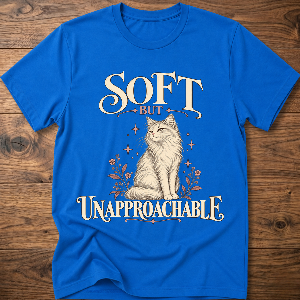 Royal blue soft cat T-shirt with front cat graphic and “Soft but Unapproachable” text
