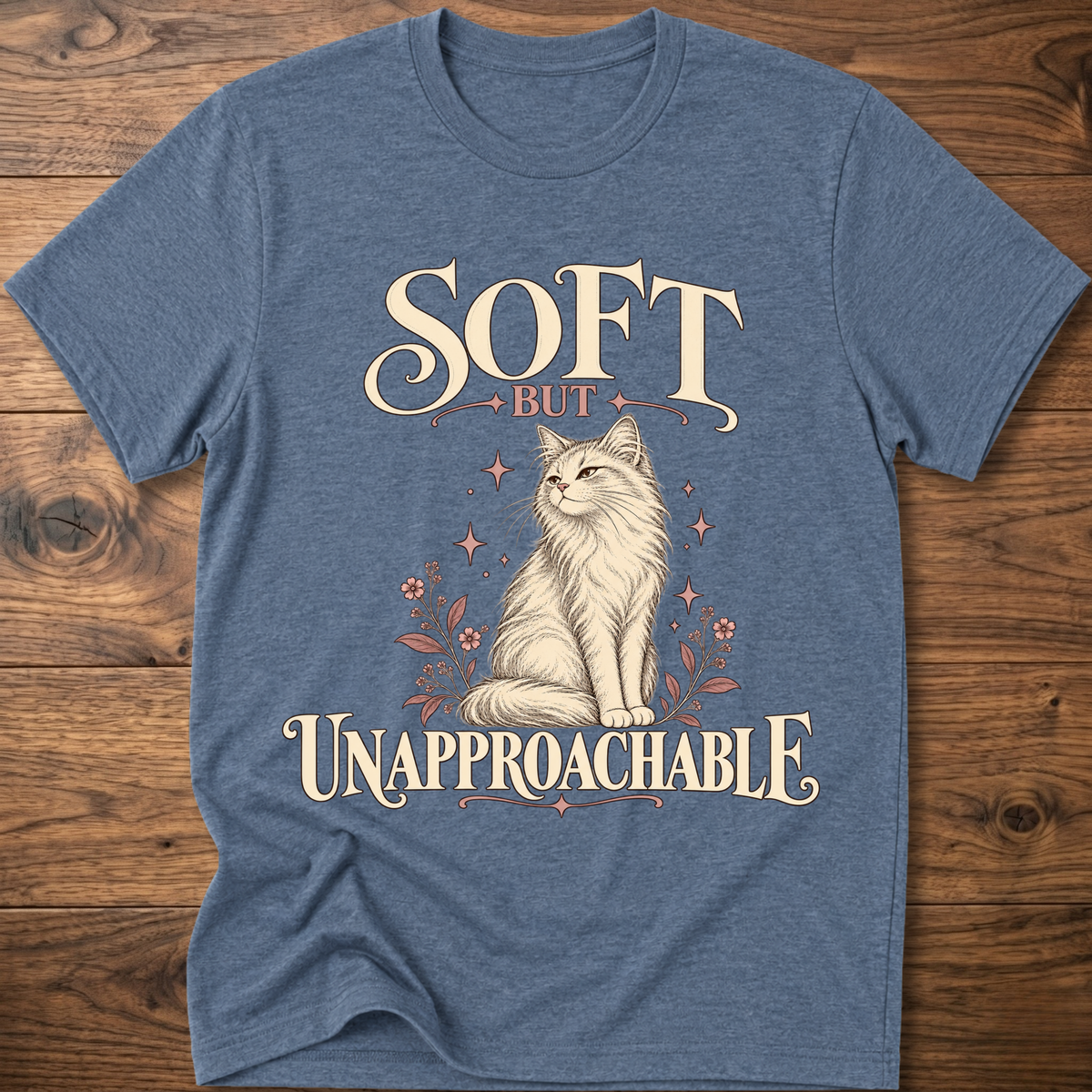 Heather blue soft cat T-shirt with front cat graphic and “Soft but Unapproachable” text