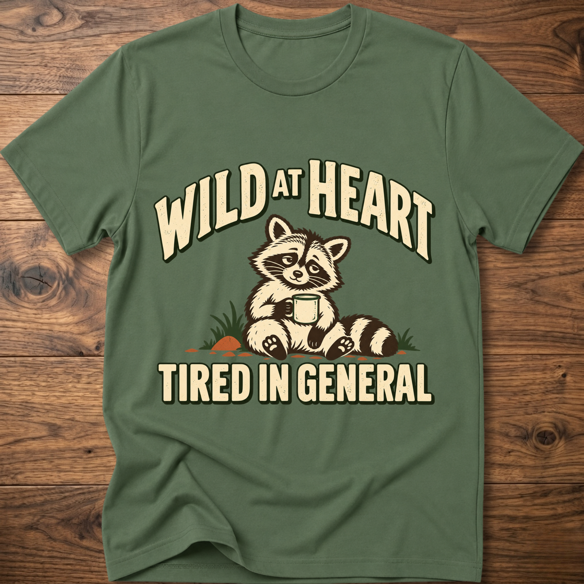 Military green crewneck t-shirt with raccoon graphic and “WILD AT HEART” text