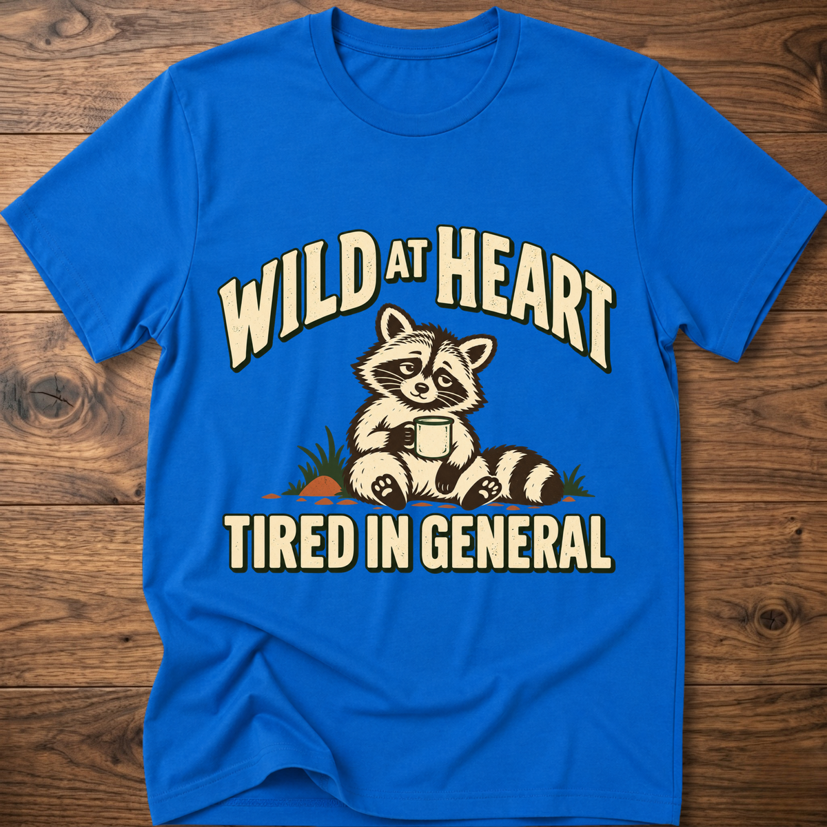 Royal blue crewneck t-shirt with raccoon graphic and “WILD AT HEART” text
