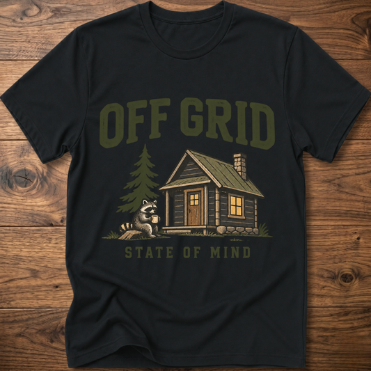 Black T-shirt with “Off Grid” graphic, cabin house, pine tree, and raccoon
