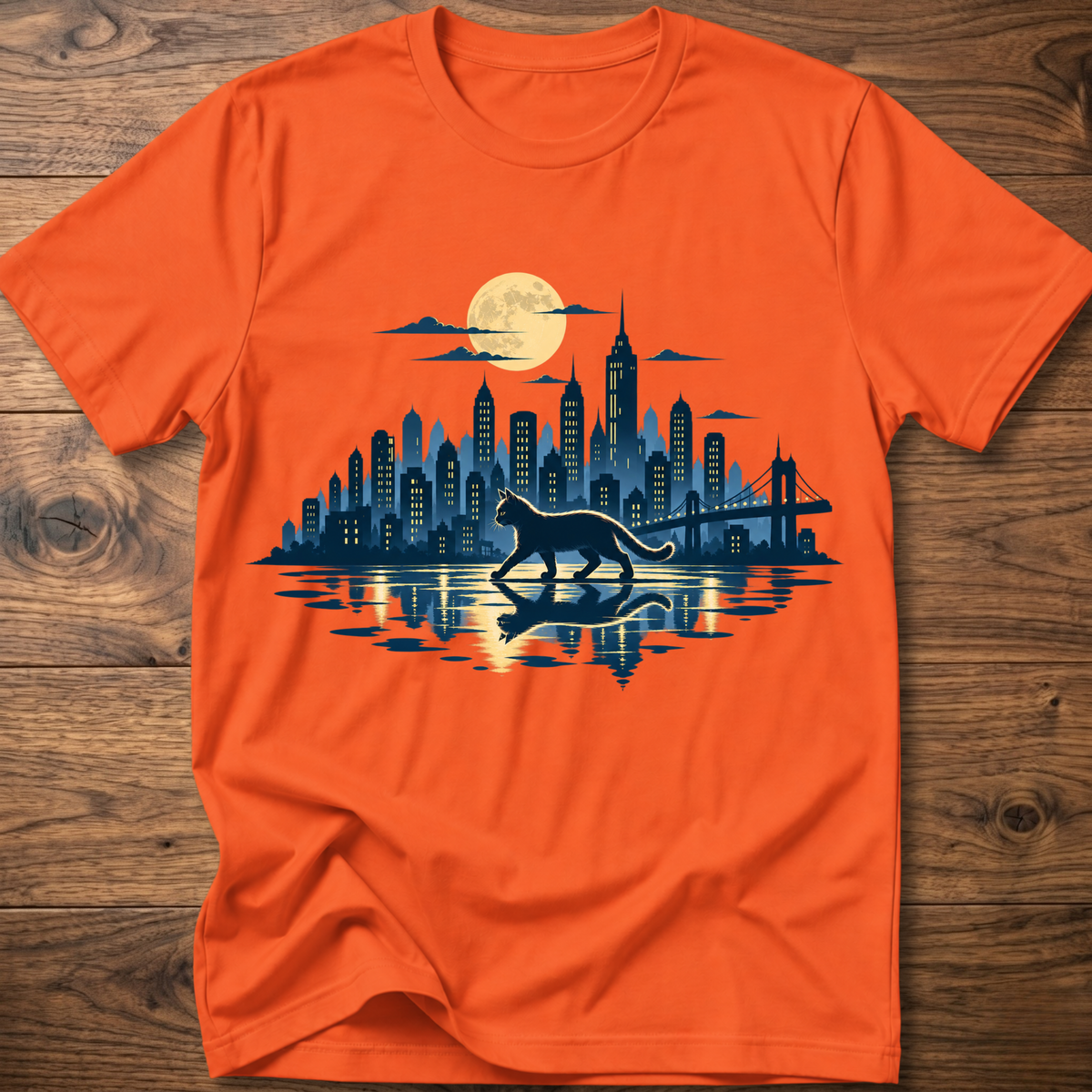 Orange short-sleeve T-shirt with cat and city skyline graphic at center