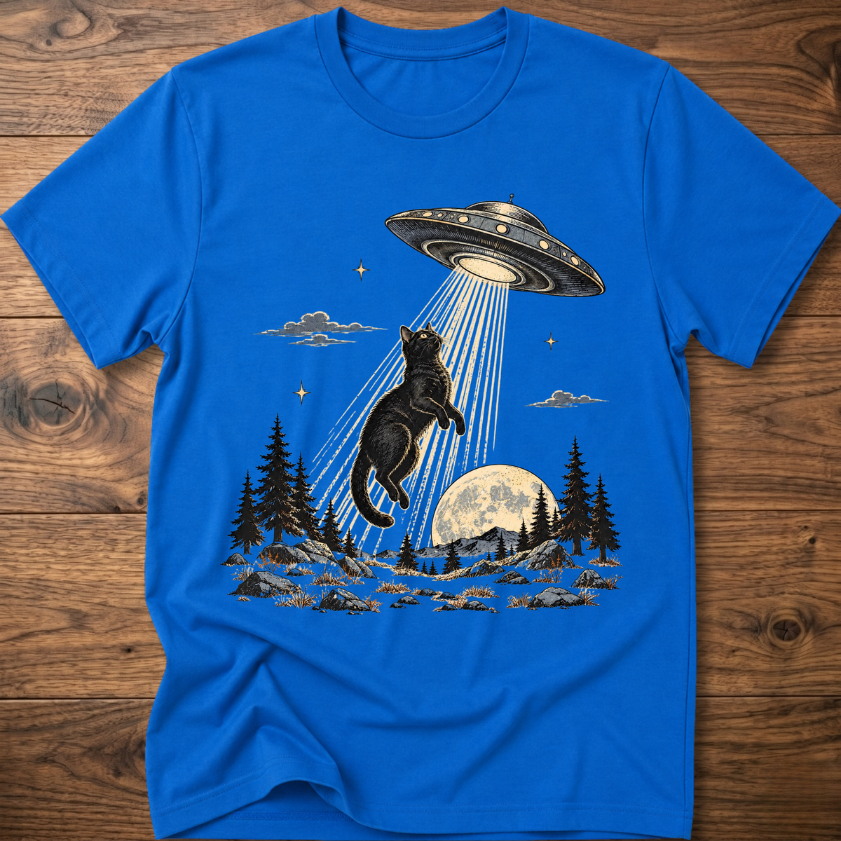 Royal blue crewneck t-shirt with black cat under UFO beam over forest night scene