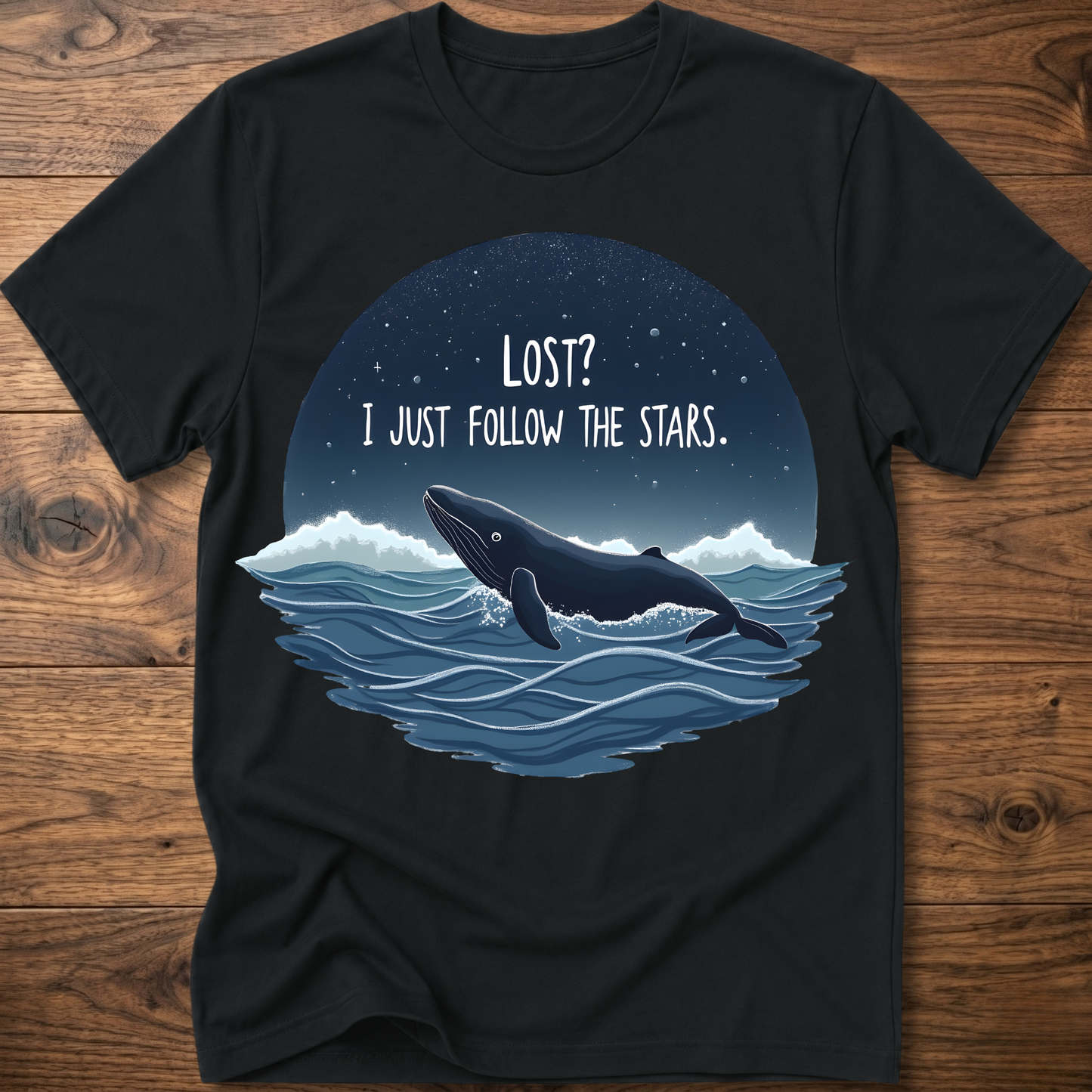 Black whale graphic t-shirt with circular “LOST? I JUST FOLLOW THE STARS.” print