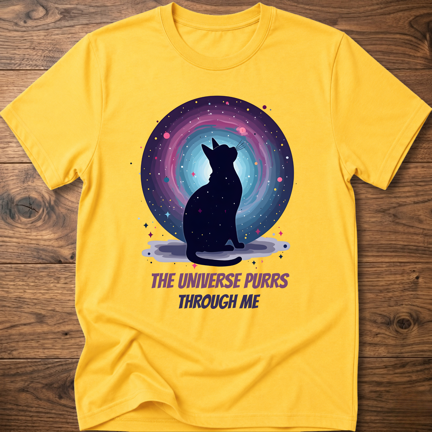 Yellow cat t-shirt with cosmic cat silhouette and purple "The universe purrs through me" text