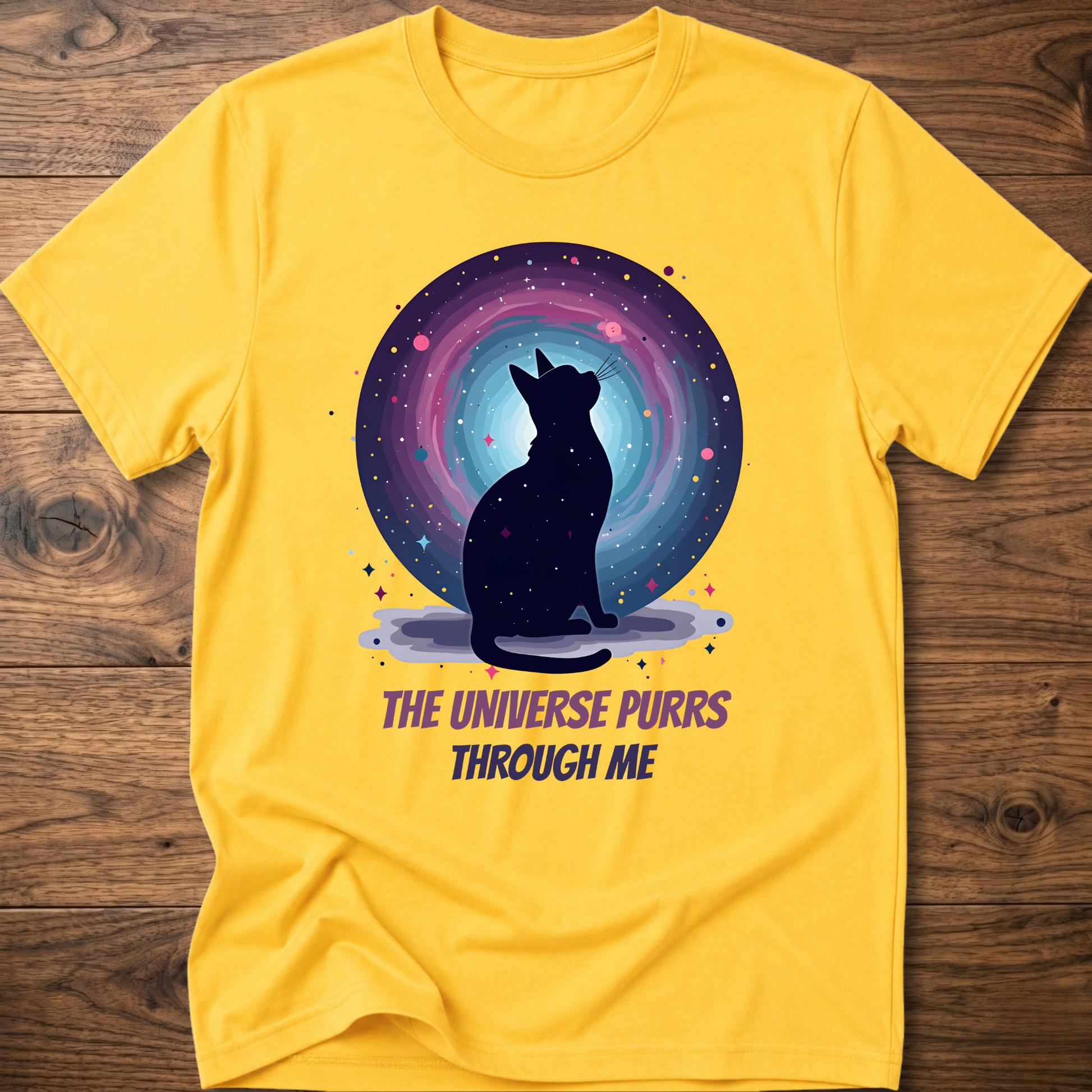Yellow cat t-shirt with cosmic cat silhouette and purple "The universe purrs through me" text