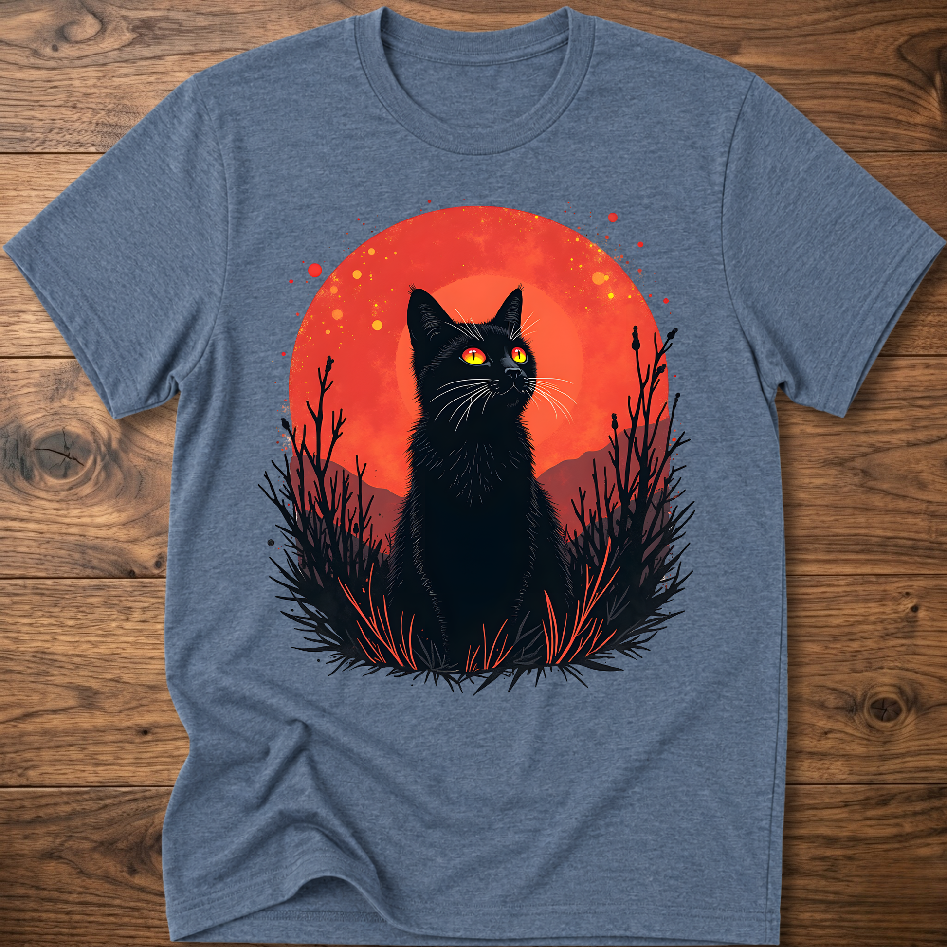 Heather blue T-shirt with black cat graphic in red-orange halo and night-plant silhouettes