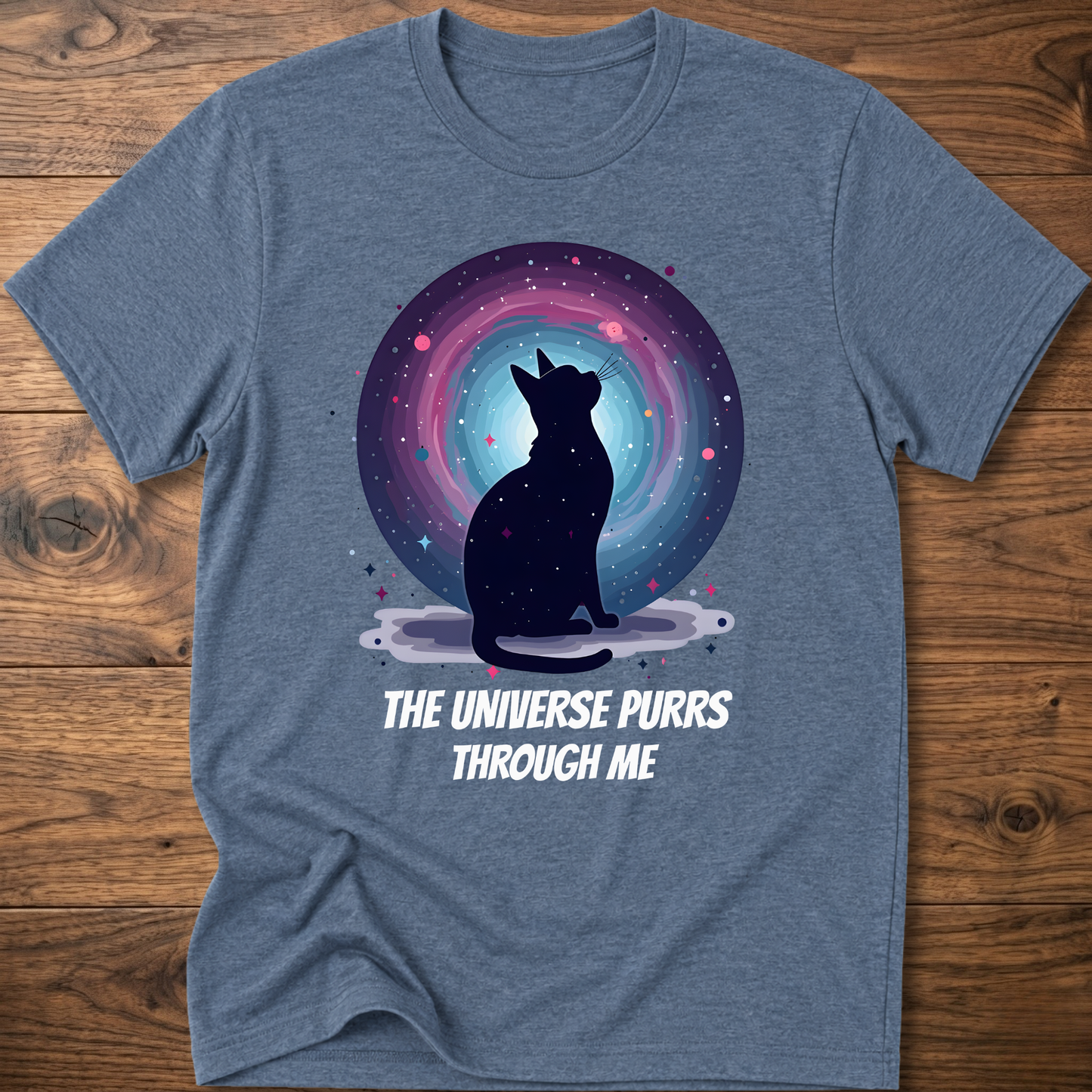Heather blue cat t-shirt with cosmic cat silhouette and purple "The universe purrs through me" text