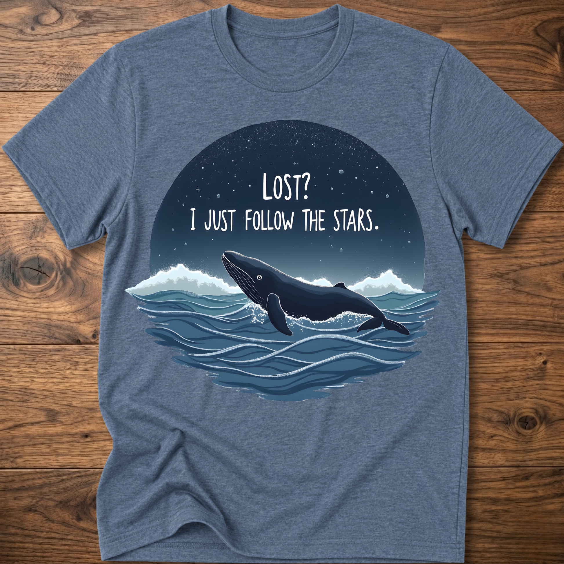 Heather blue whale graphic t-shirt with circular “LOST? I JUST FOLLOW THE STARS.” print