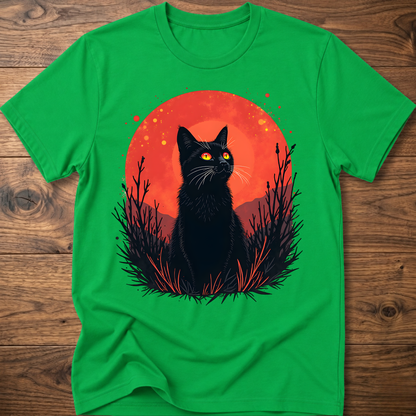 Green T-shirt with black cat graphic in red-orange halo and night-plant silhouettes