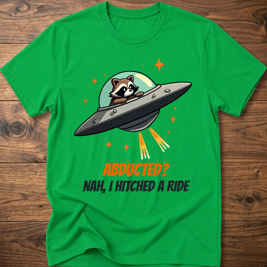 Green raccoon graphic t-shirt with UFO and orange "ABDUCTED?" text
