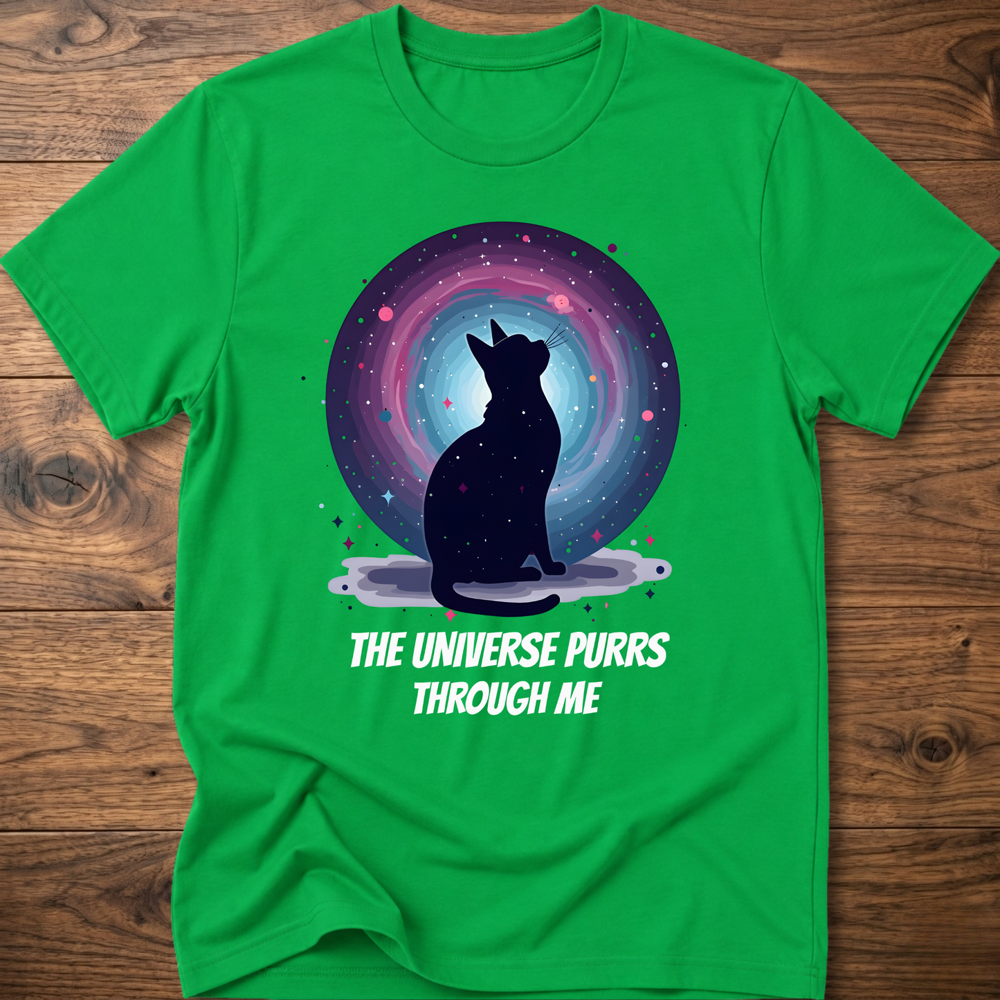 Green cat t-shirt with cosmic cat silhouette and white "The universe purrs through me" text