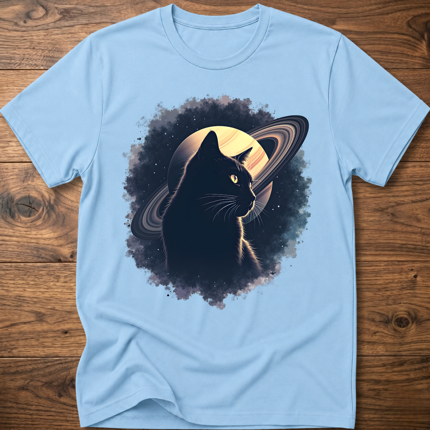 Light blue cat graphic t-shirt with moon and swirl design, crew neck short sleeves