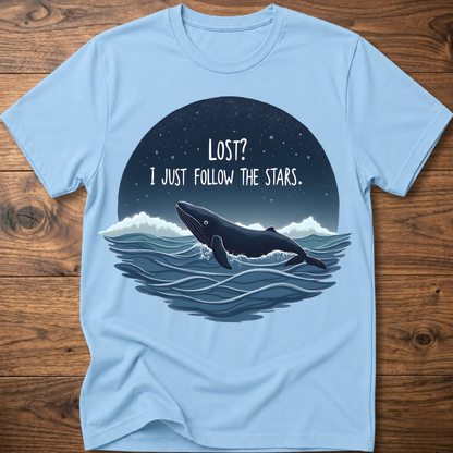 Light blue whale graphic t-shirt with circular “LOST? I JUST FOLLOW THE STARS.” print