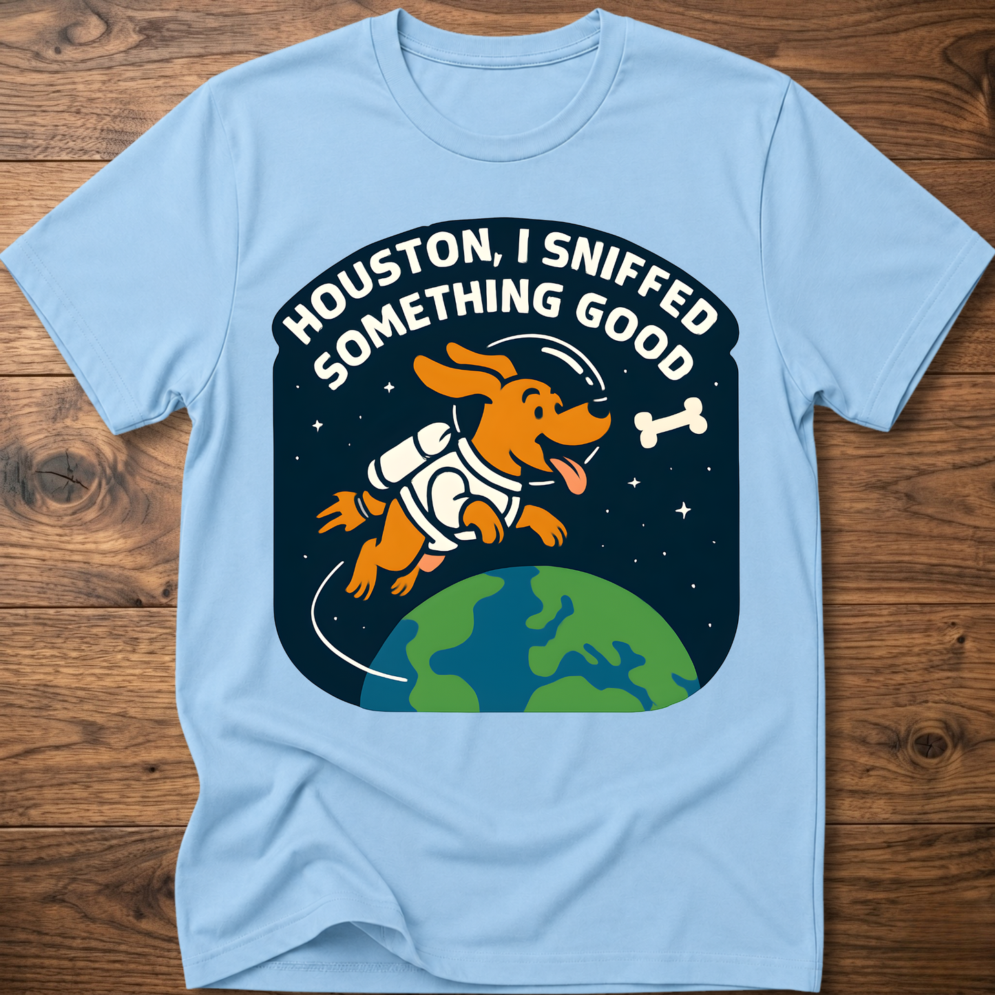 Light blue dog-themed graphic T-shirt with bone and earth illustration