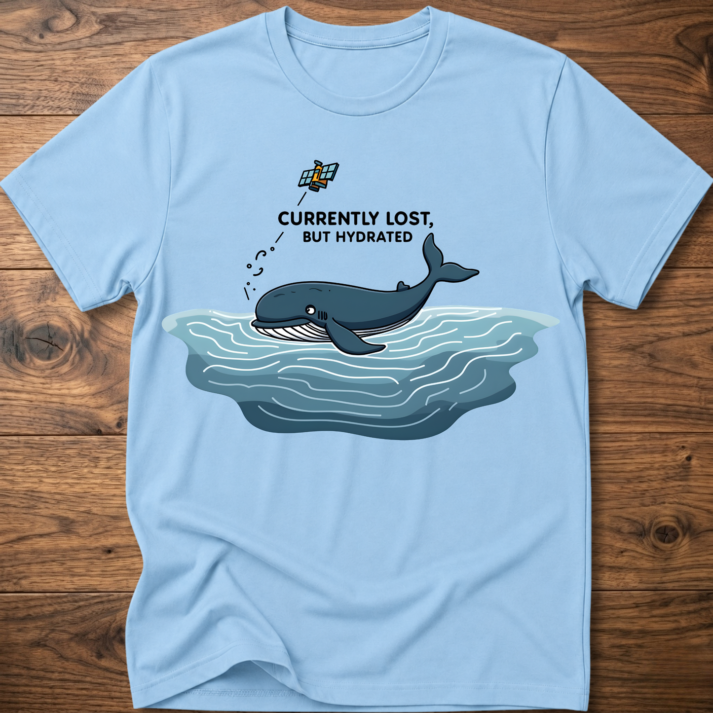Light blue crew-neck T-shirt with whale in water graphic on chest