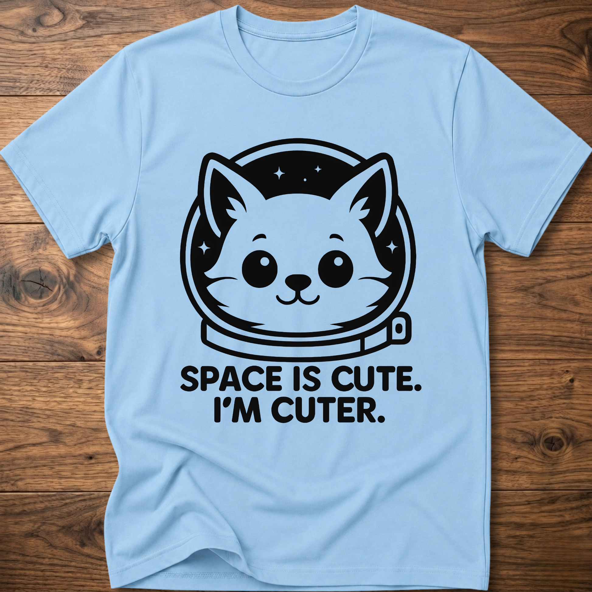 Light blue T-shirt with space cat face graphic and text "SPACE IS CUTE. I'M CUTER."