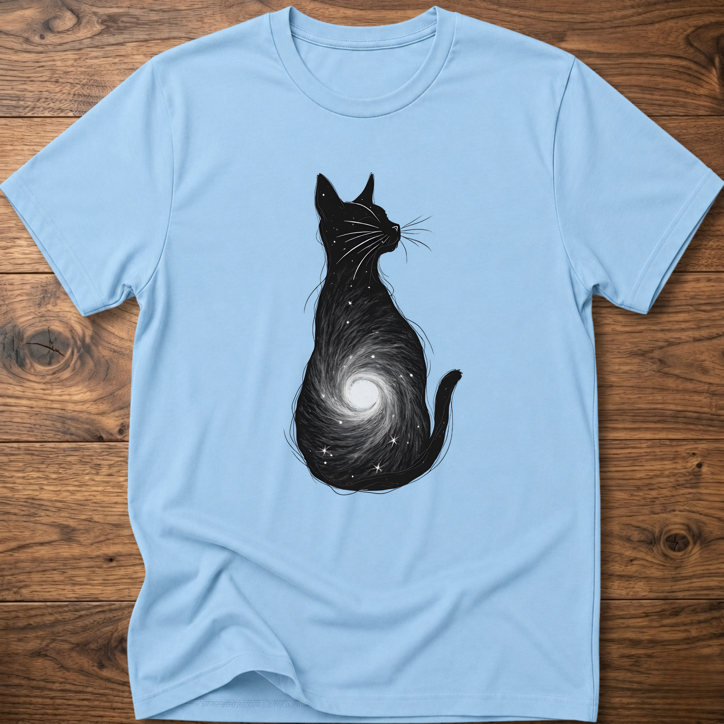 Light blue cat graphic t-shirt with black cat silhouette and spiral galaxy swirl